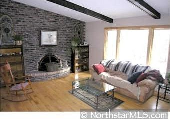 The upper level living room features one of the 3 full brick fireplaces, Maple