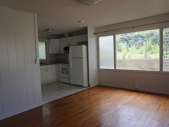 Living room flows into kitchen with back door