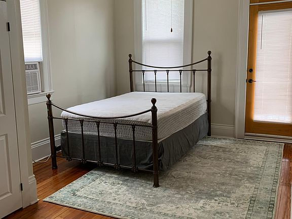 Bedroom with new A/C & Heat unit, large closet, and balcony.