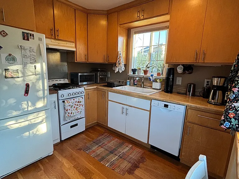 Kitchen includes refrigerator, gas stove, and newer Bosch dishwasher