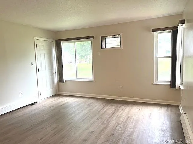 FRONT OF LIVING ROOM WITH ACCESS TO OUTDOOR DECK OFF TO THE LEFT.., NEWER WALL A/C UNITS HAVE BEEN INSTALLED.