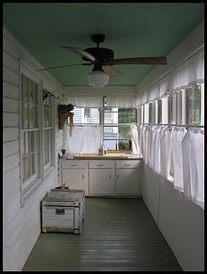 Enclosed front porch that runs the length of the home