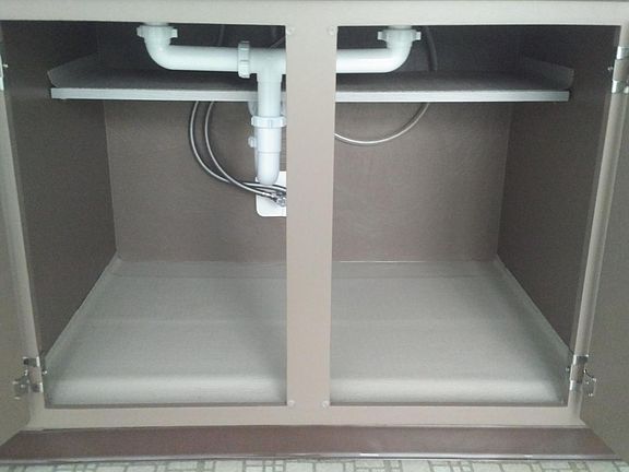 Clean and spacious undersink storage.
