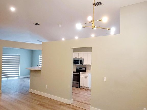 Modern light fixtures and vaulted ceiling.