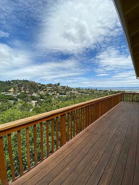 116 Madera Ave-an executive home perfect for entertaining at the top of a hill with views to the east bay from every room upstairs. A back deck runs the length of the house as do a wall of windows.