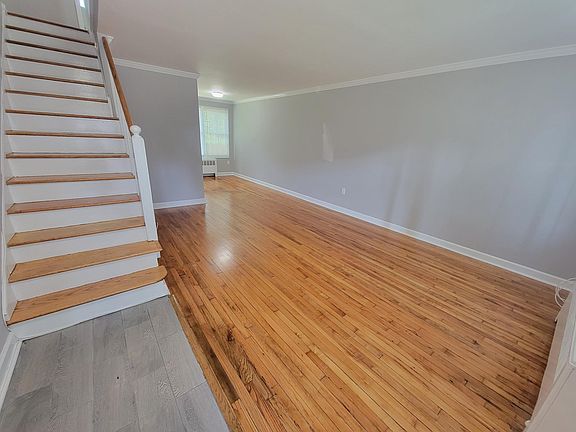 Living and Dining room combo with gleaming hardwood floors.