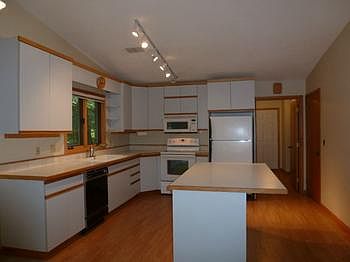 Large open kitchen is bright and airy! A center island is great for added work space and entertainin