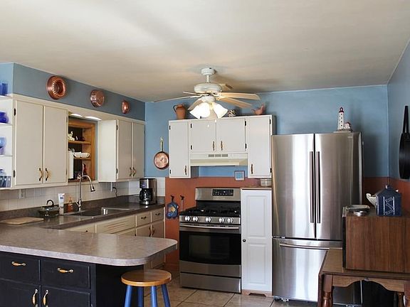 Kitchen with open pass through to living room. Breakfast bar