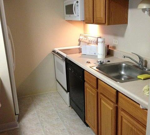 Galley Kitchen open to LR with dishwasher and microwave.