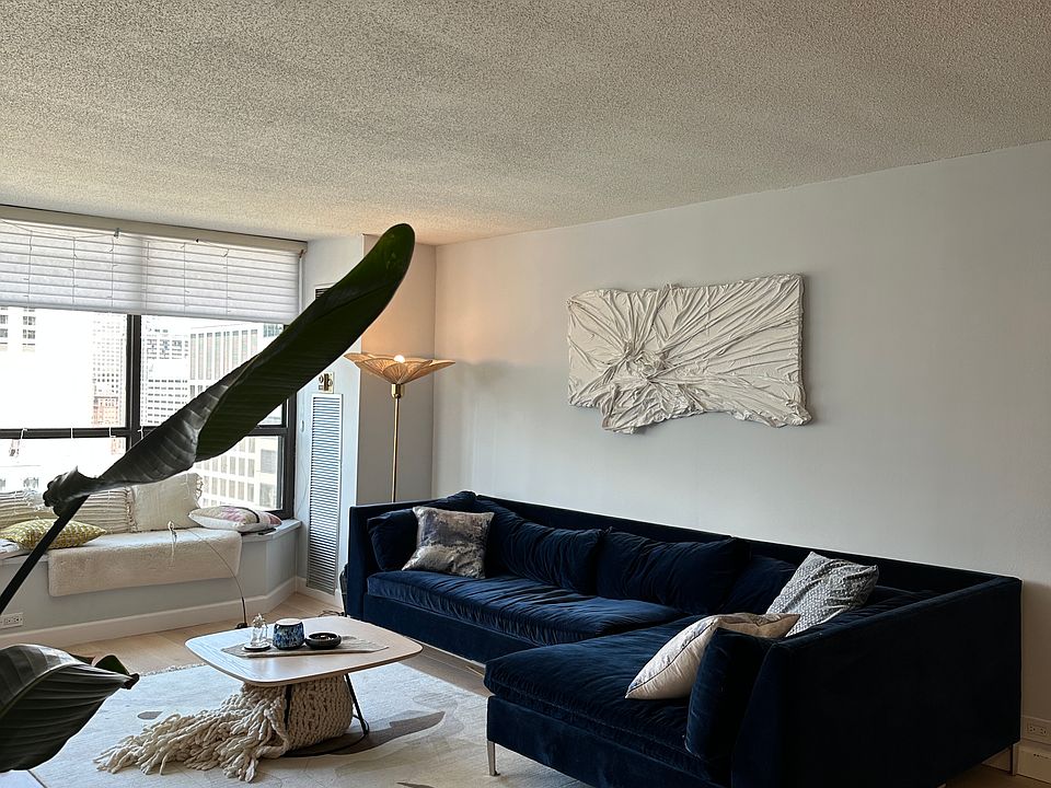 large open living room with modern CB2 furniture and ACCs, window seating with pillows and oomphy blankets