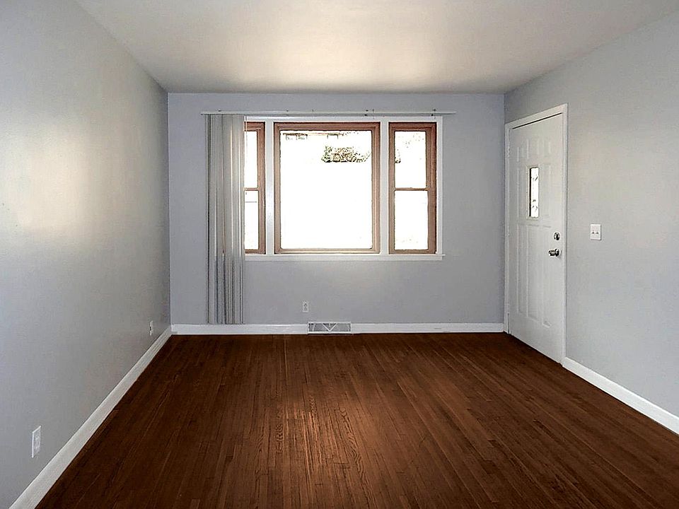 Living room with beautifully renovated dark hardwood floors.