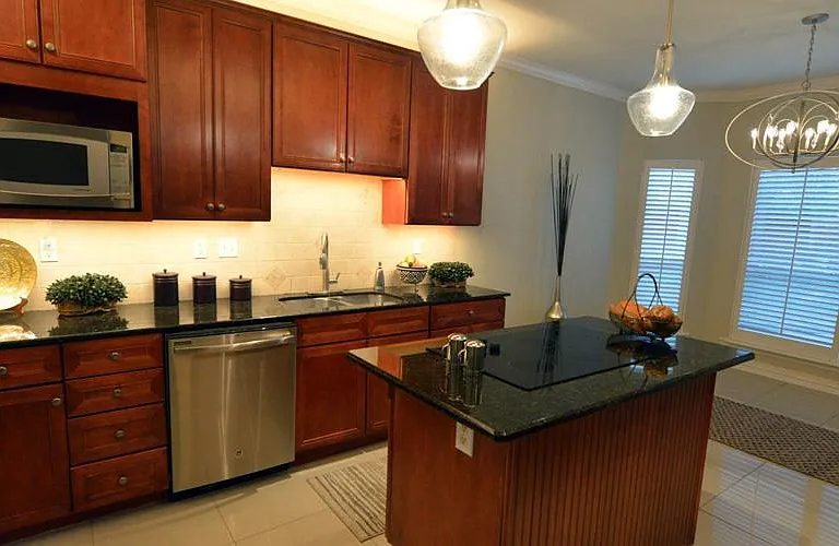 Island kitchen with LED pendant lights and recessed lighting