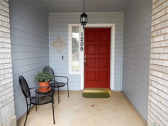 Welcoming front door with room for seating and/or decoration.