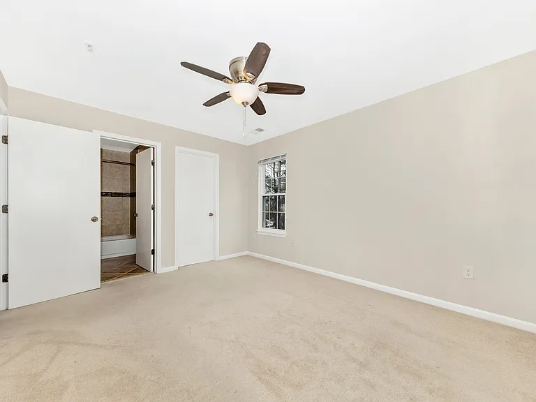 Primary bedroom off of living room, unstaged.