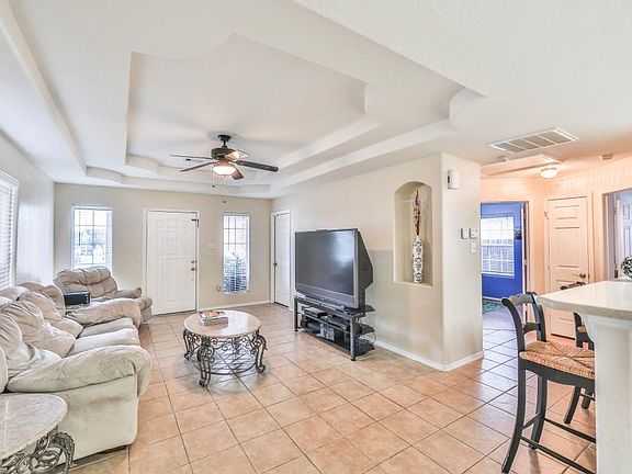 Family room also features a wall cut out & tile flooring.