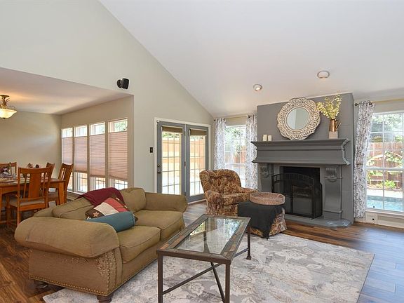 High ceilings, high quality wood laminate floors, gas log fireplace and views of the pool as you relax in your living room.