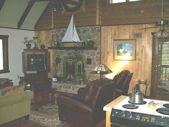Great Room with vaulted ceiling, fireplace, and skylights.