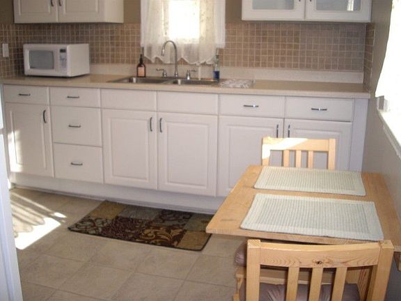 Remodeled kitchen with new cabinets and its own eating space.