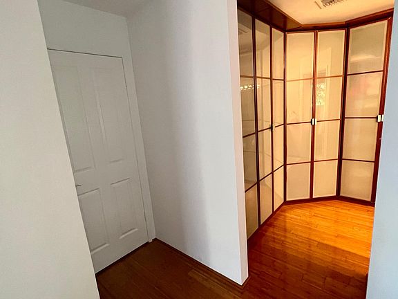 entrance to master bedroom with custom cabinets / closets