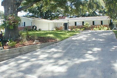Mature Oaks surround home