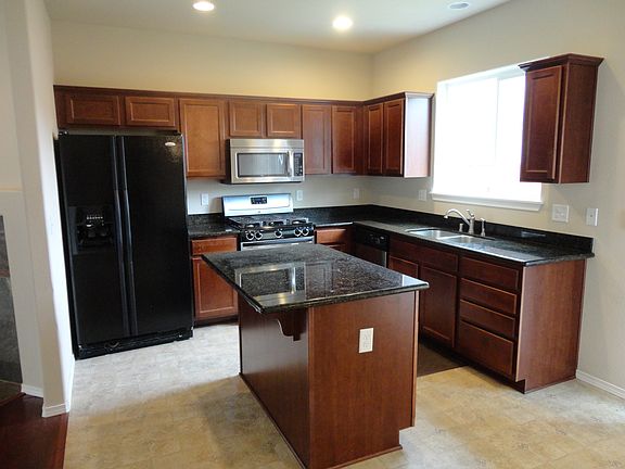 Kitchen with granite counters & gas stove
