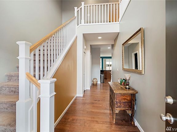 Vaulted ceilings, laminate flooring, and an open stairway as you enter!