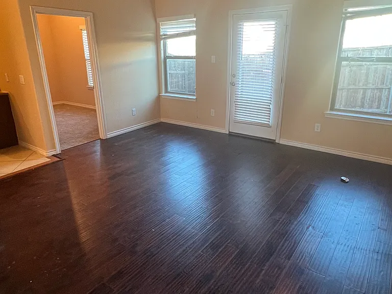 Living room area down the hall open to kitchen and 1 bedroom downstairs