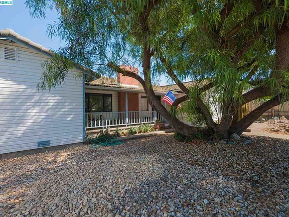 Large .25 Sq Ft lot with side yard access, detached large two car garage and storage sheds.