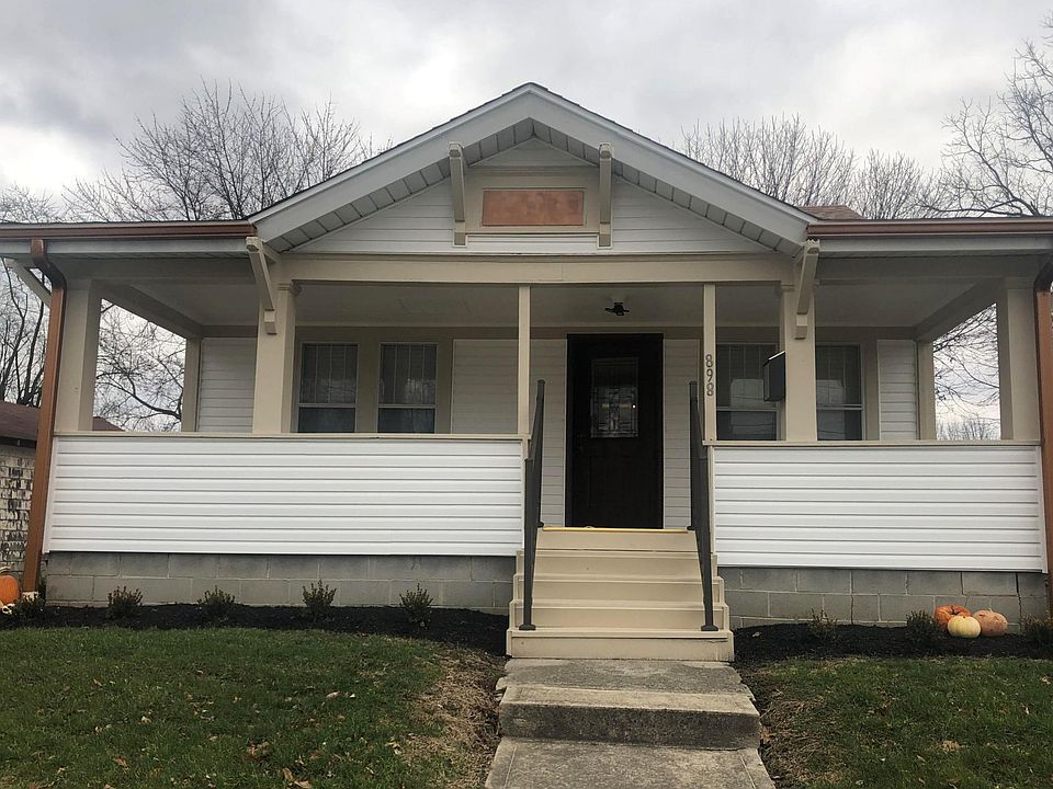 New siding and gutters and freshly painted front porch