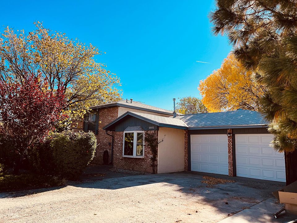 Front of house with new garage doors and large driveway