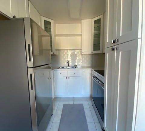 fully renovated kitchen with stainless steel appliances and quartz countertop