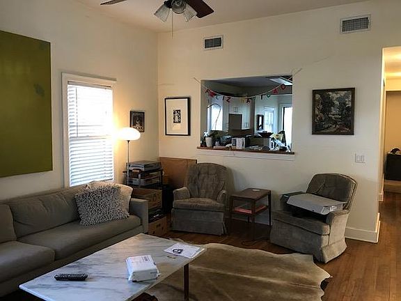 View from the front door of the vaulted living room. kitchen on the other side of cut out.