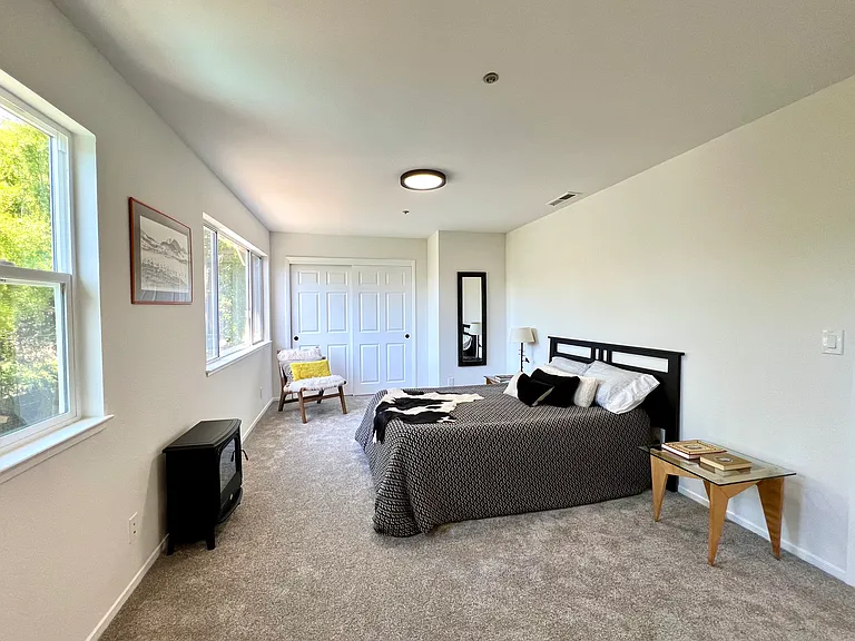 Primary bedroom overlooks backyard