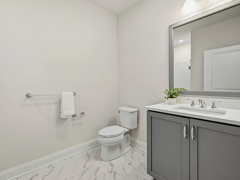 Spacious full bathroom in the 4th Bedroom ensuite features quartz vanity and subway-tiled stall shower.
