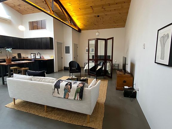 Kitchen/Dining Area (l), Sleeping Area (r), Living Area (foreground)