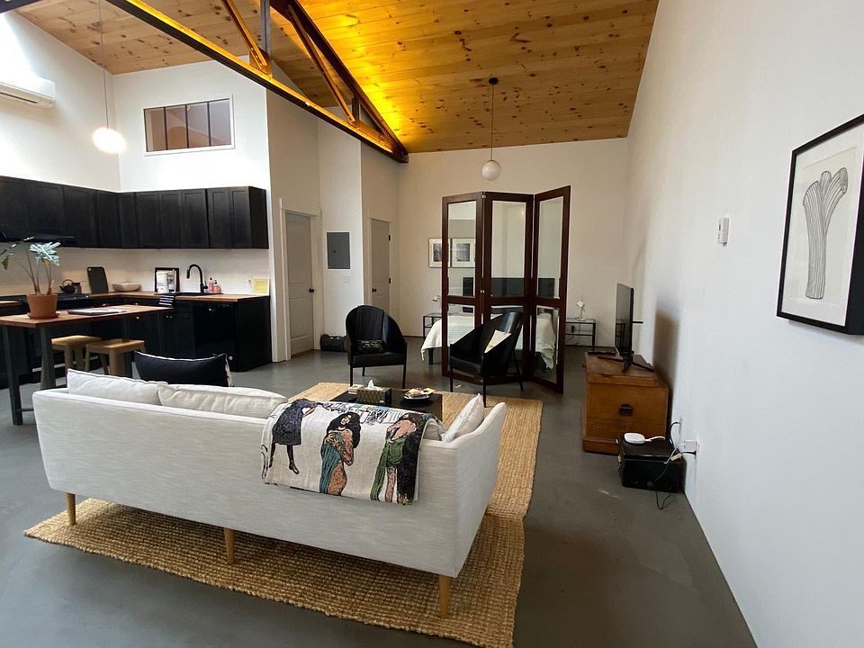 Kitchen/Dining Area (l), Sleeping Area (r), Living Area (foreground)