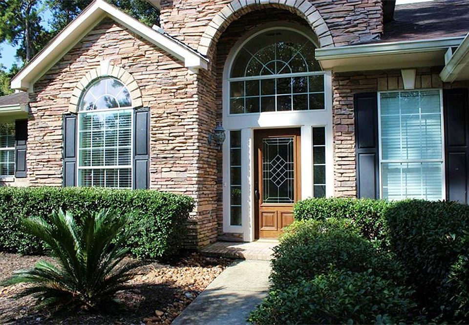 Lovely stacked stone front elevation and front door entry of home.