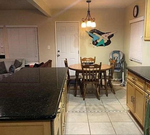 Remodeled kitchen and eating area. Door to back yard. Open to living room on left