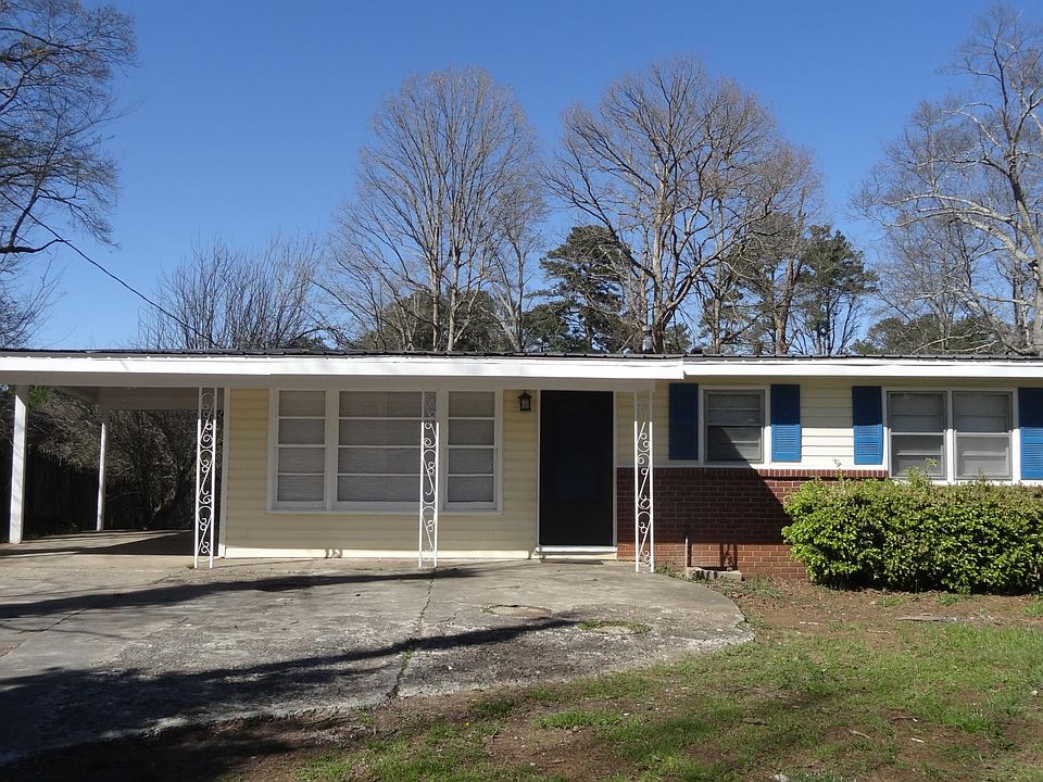 Ample parking with carport and parking pad.