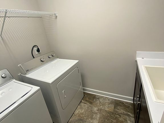 laundry/mud room with a sink and storage space