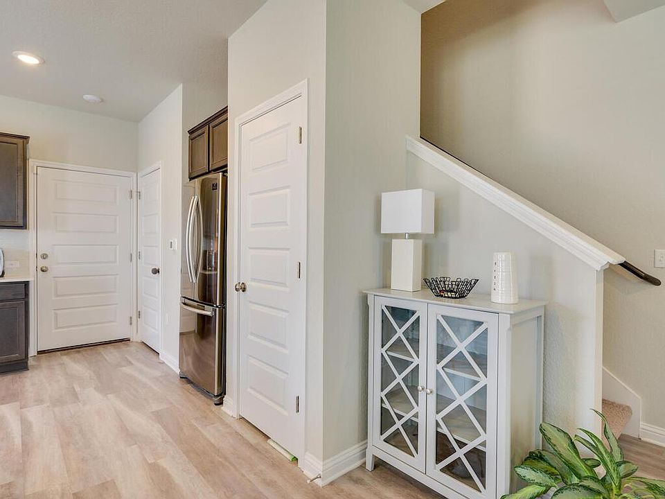 Door on left leads to 2 car garage, middle door leads to half bathroom and door on right is a pantry.