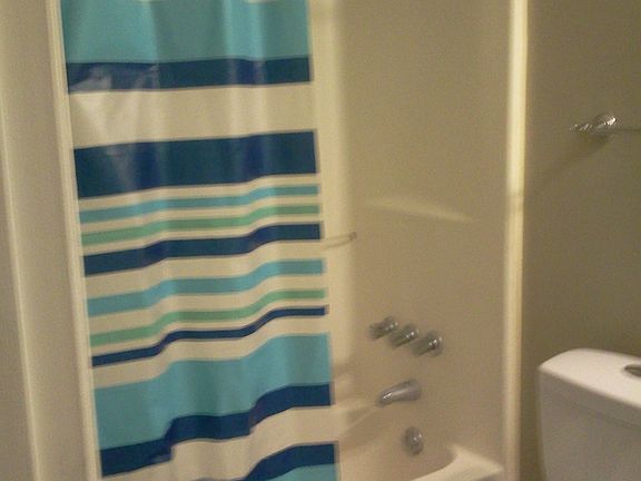 Full bath with pedestal sink and beautiful stone tile.
