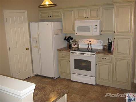 Your newly remodeled kitchen full of new appliances that include a flat top range, overhead microwave, refrigerator and disposal. More spacious cabinetry on the other side, along with a bar ledge, ready for bar stools and entertaining.