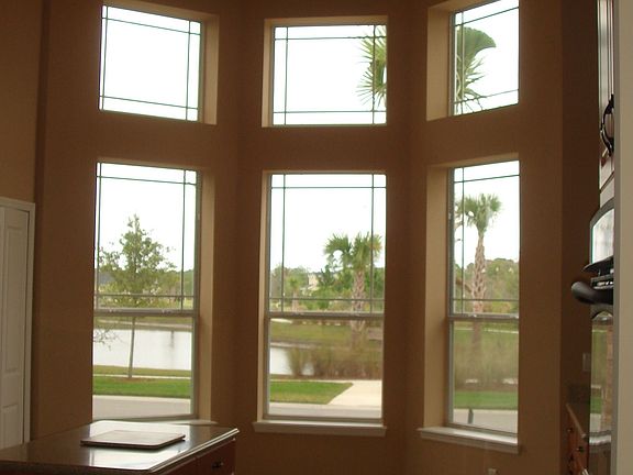This view shows the kitchen's vaulted ceilings and the "wall of windows" that have a great view of the lake and park across the street.  This photo does not do the view justice.  For a private showing, more photos and floorplans, email sales@helmick.net