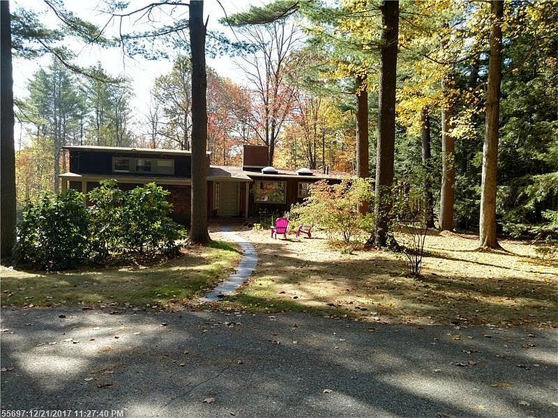 Set back from the road at the end of a dead-end street on nearly 2 acres with acres of woods beyond.