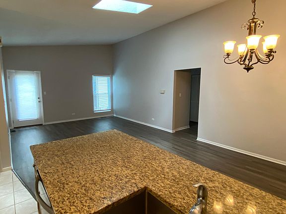 View from kitchen to living/dining area, door to back yard.