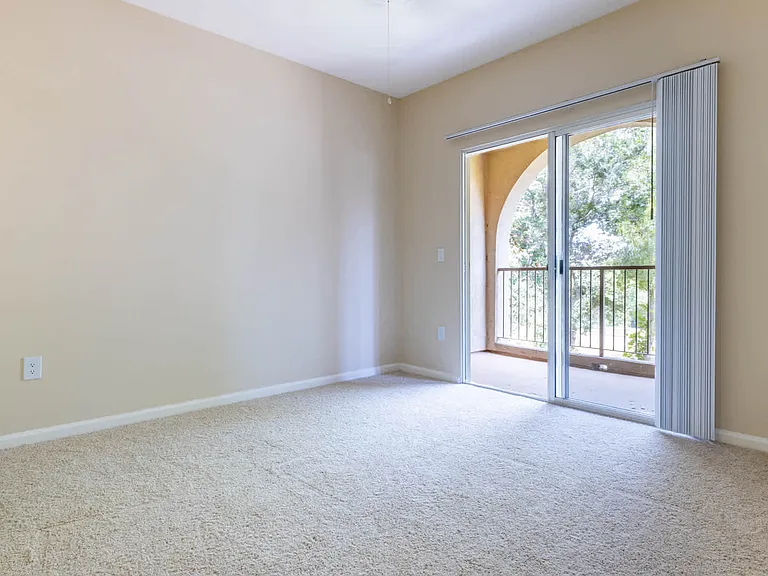 Carpeted Bedroom with Balcony