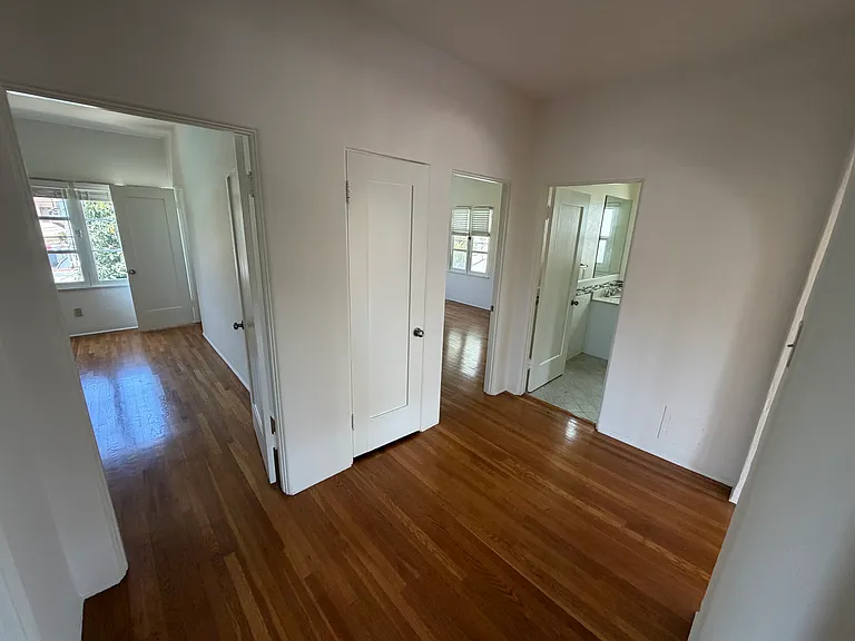 Central corridor connecting to the two bedrooms, bathroom, kitchen, living room and dining room