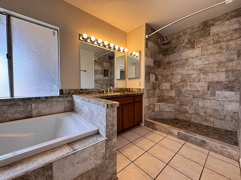 Newly renovated bathroom 1 has separate tub and shower.