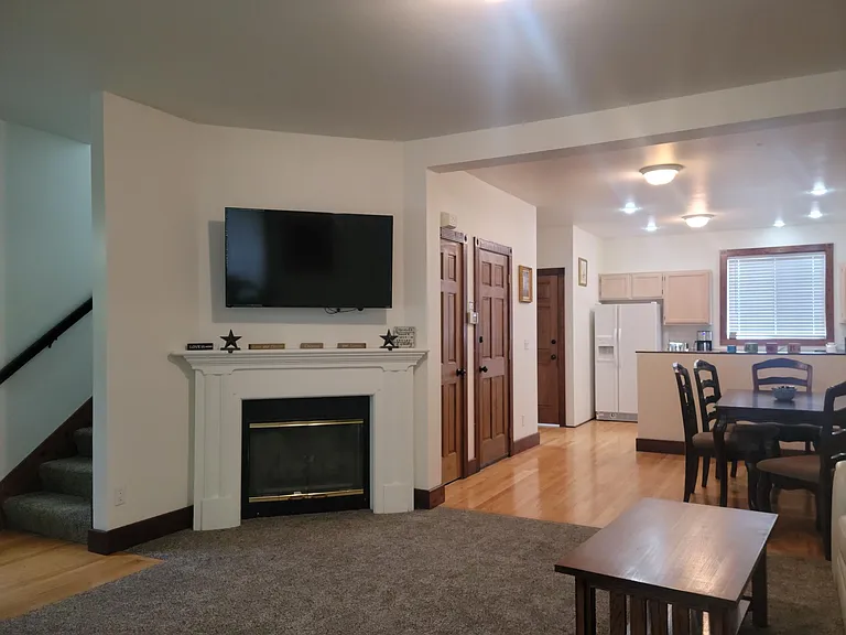 Flat screen TV in living room. Cozy natural gas stove with mantel for ambiance. 9 ft ceilings on main floor.